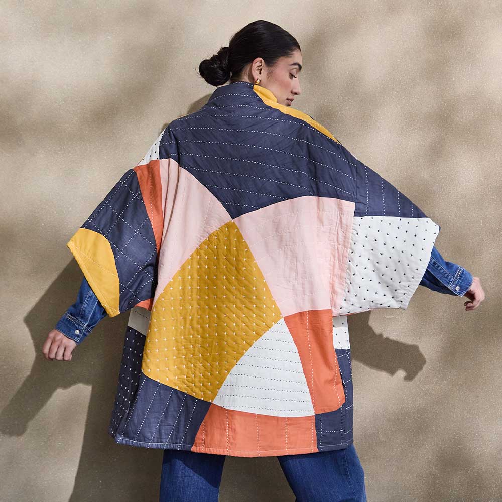 woman wearing quilted patchwork jacket with bold abstract shapes for Spring