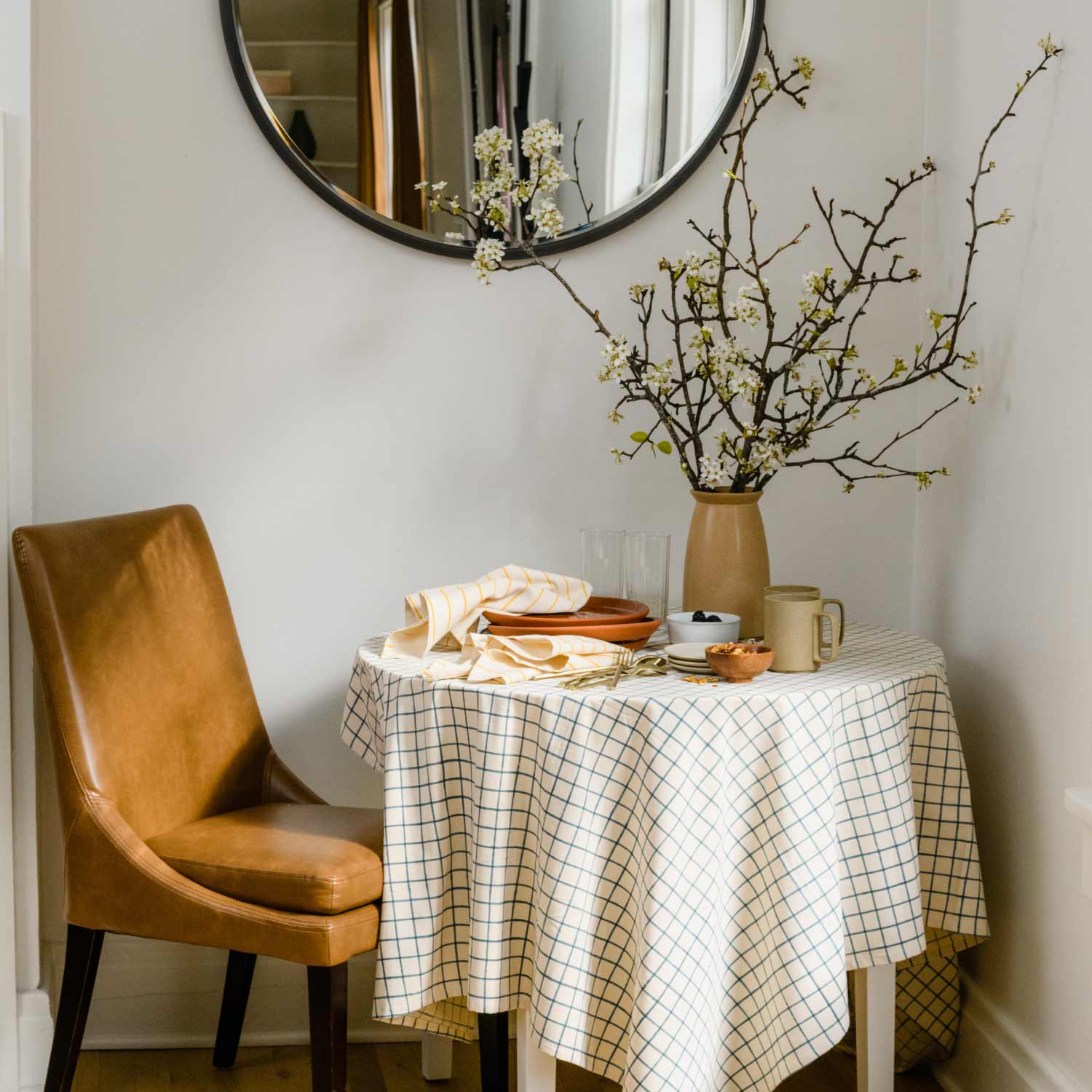 breakfast nook with round table with grid table cloth