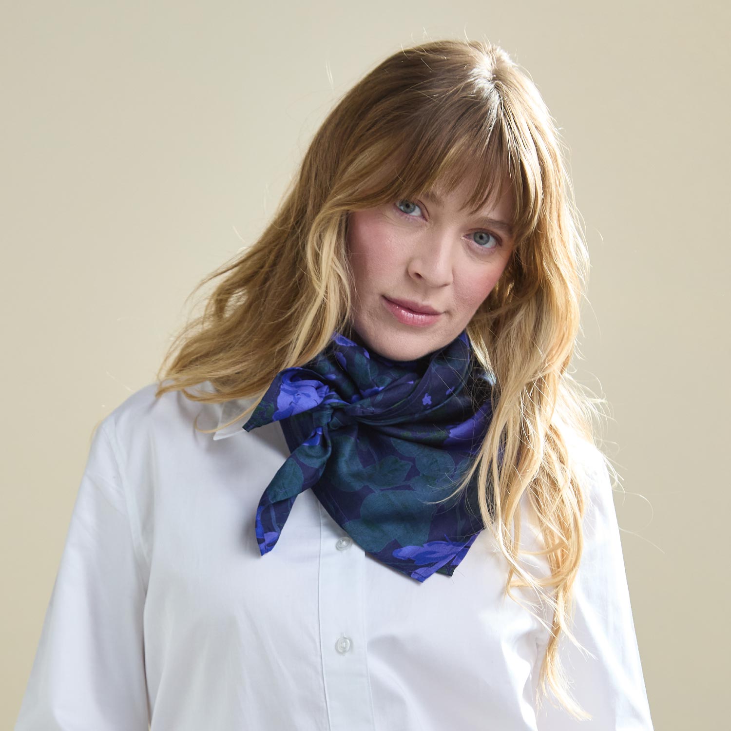 woman wearing purple silk square scarf with white button up shirt