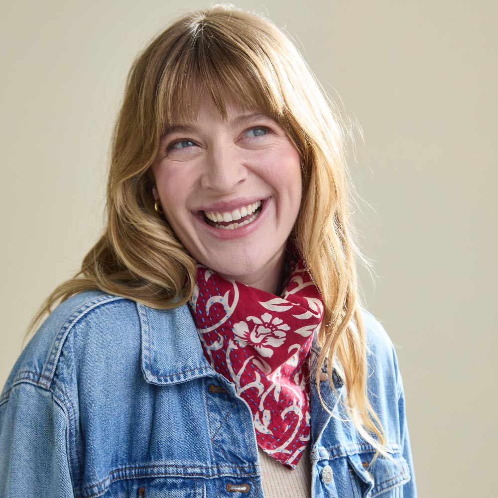 woman wearing a denim jacket with a red and white cotton bandana scarf