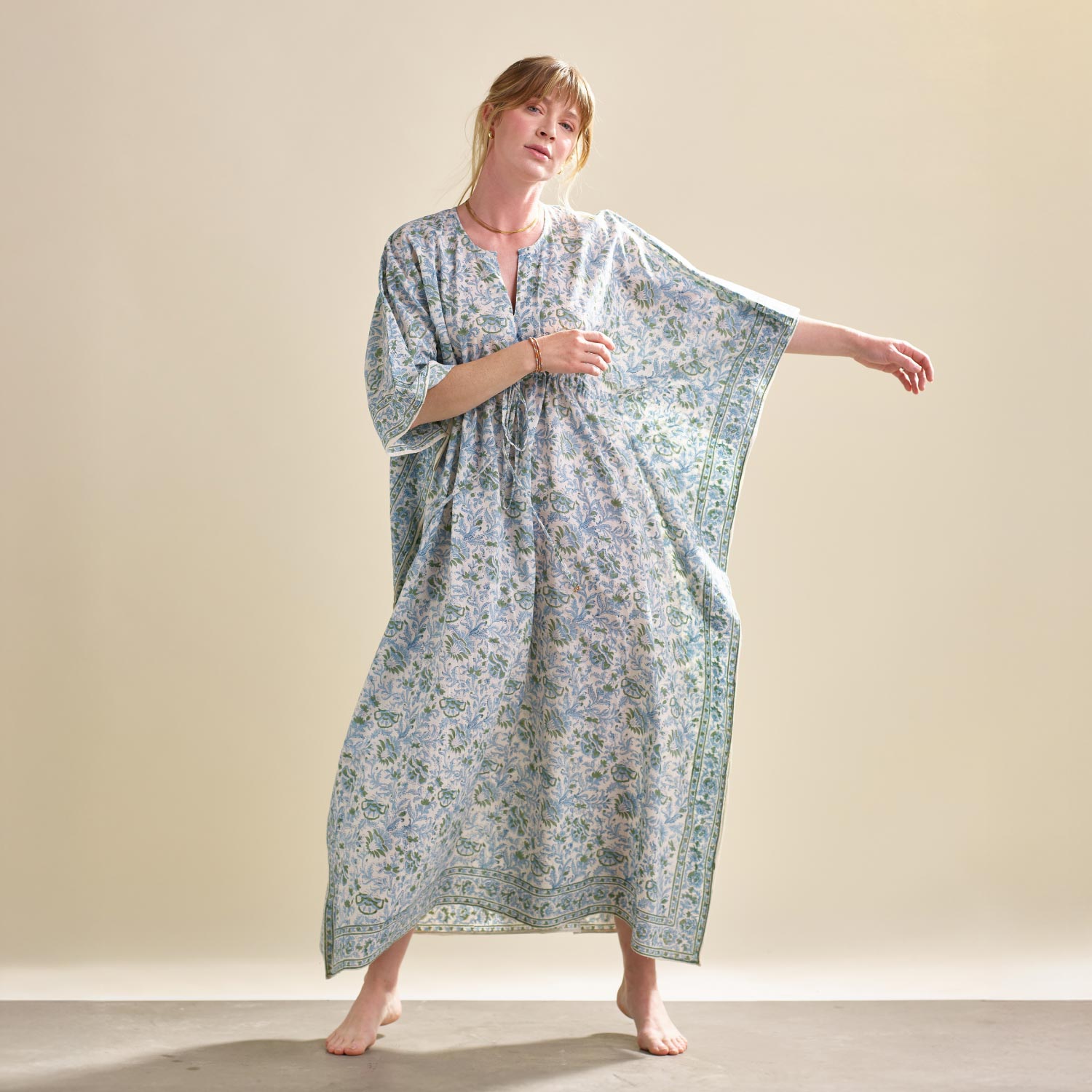 woman wearing blue floral kaftan handmade in India from 100% organic cotton