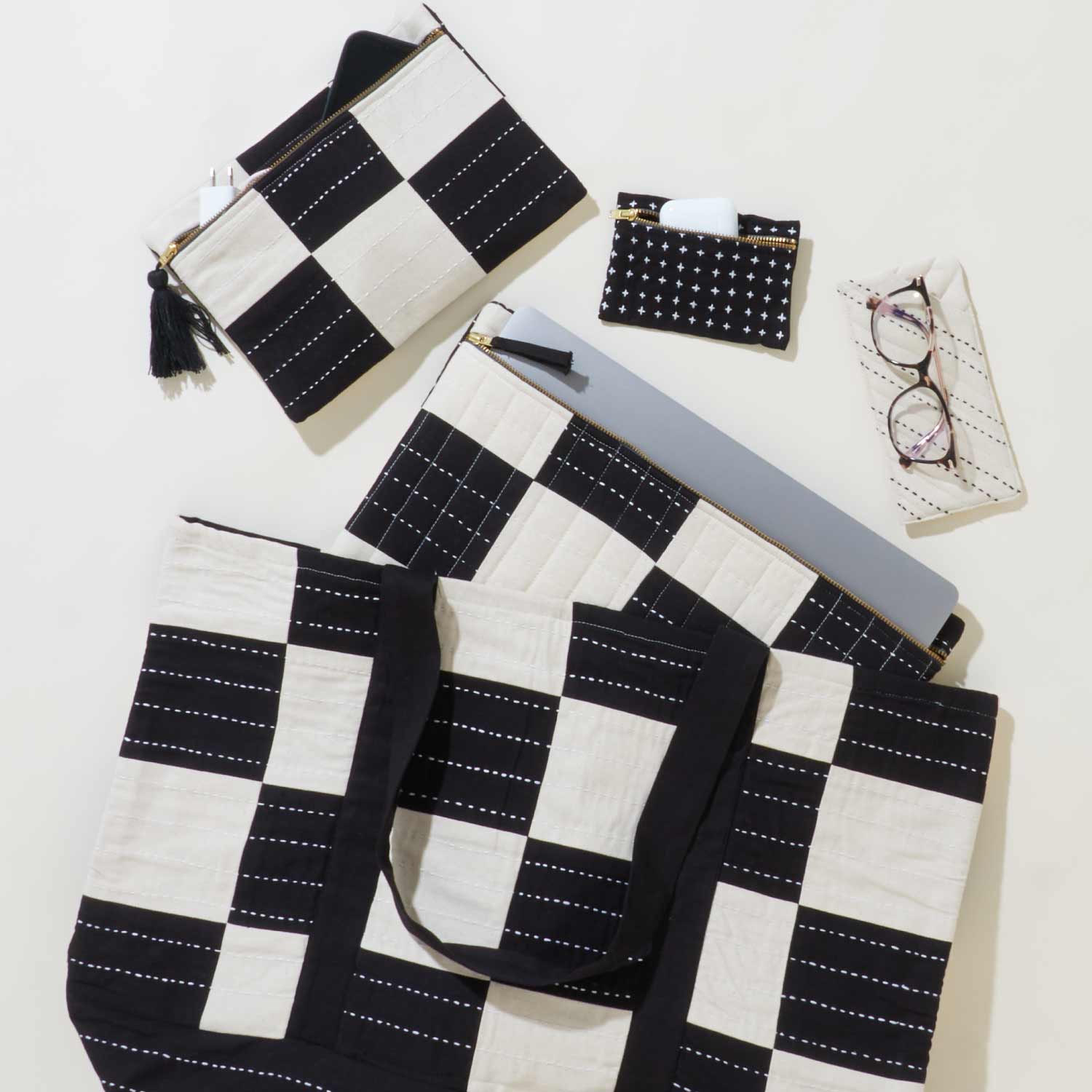 matching tote bag, laptop case and small pouch in black and white checkered print