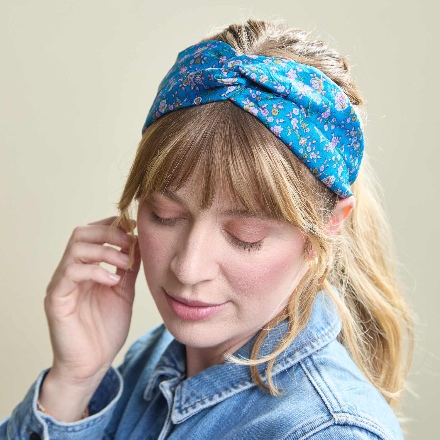 woman wearing blue floral silk twist headband