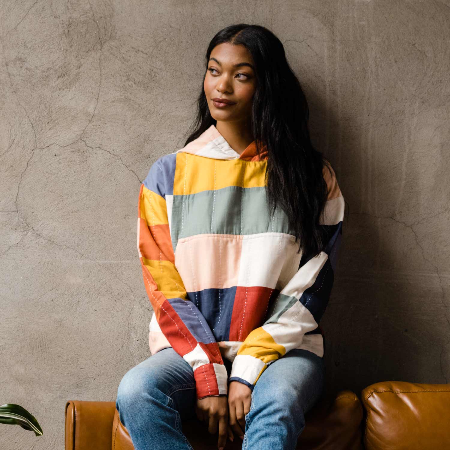 woman wearing quilted hoodie in a colorful bold checkered pattern
