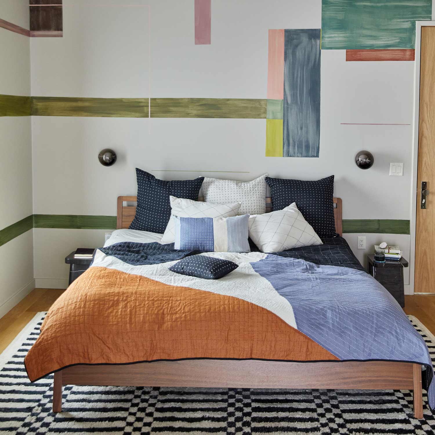 colorblock king quilt on bed with modern geometric wall mural
