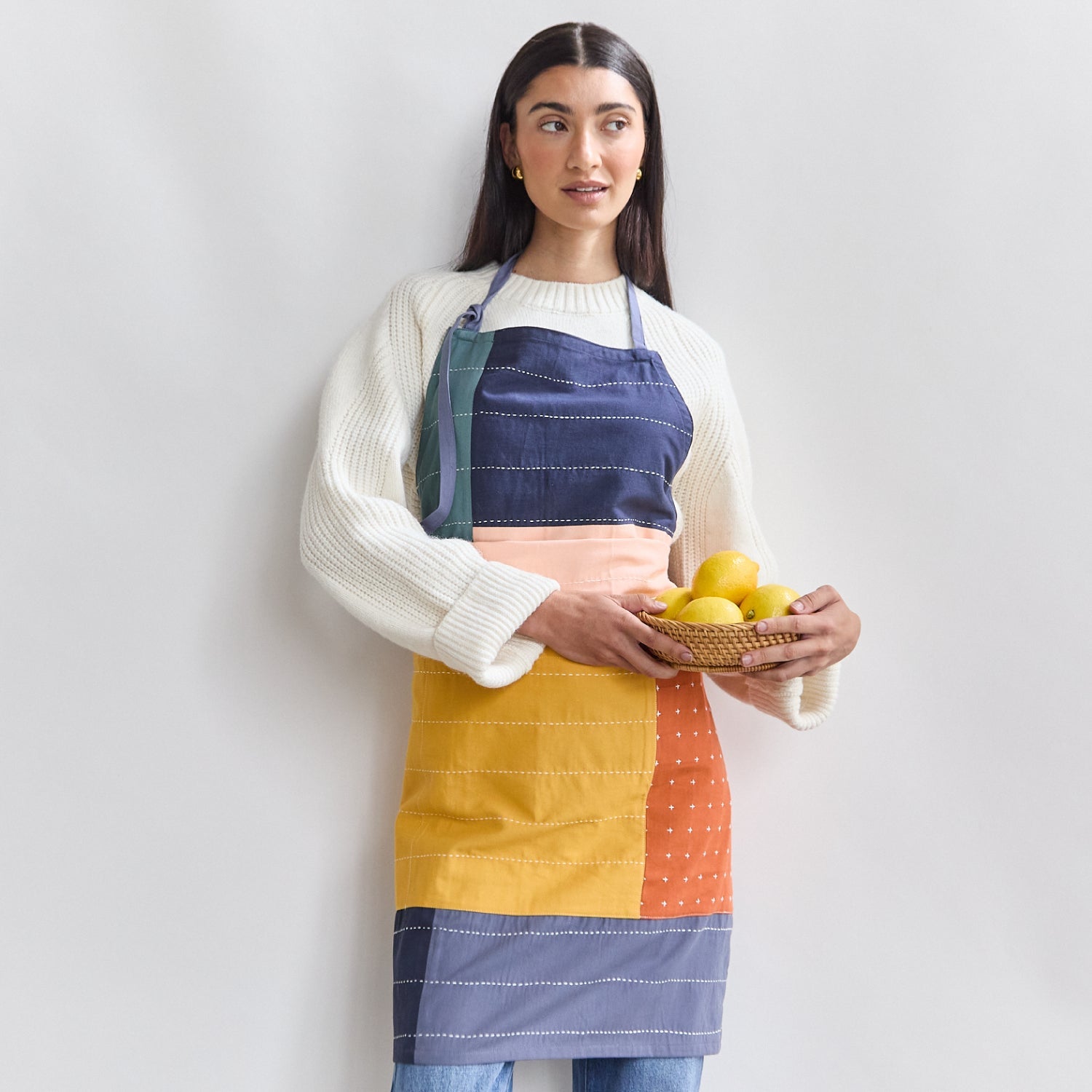 woman wearing colorblock bib apron made of 100% organic cotton
