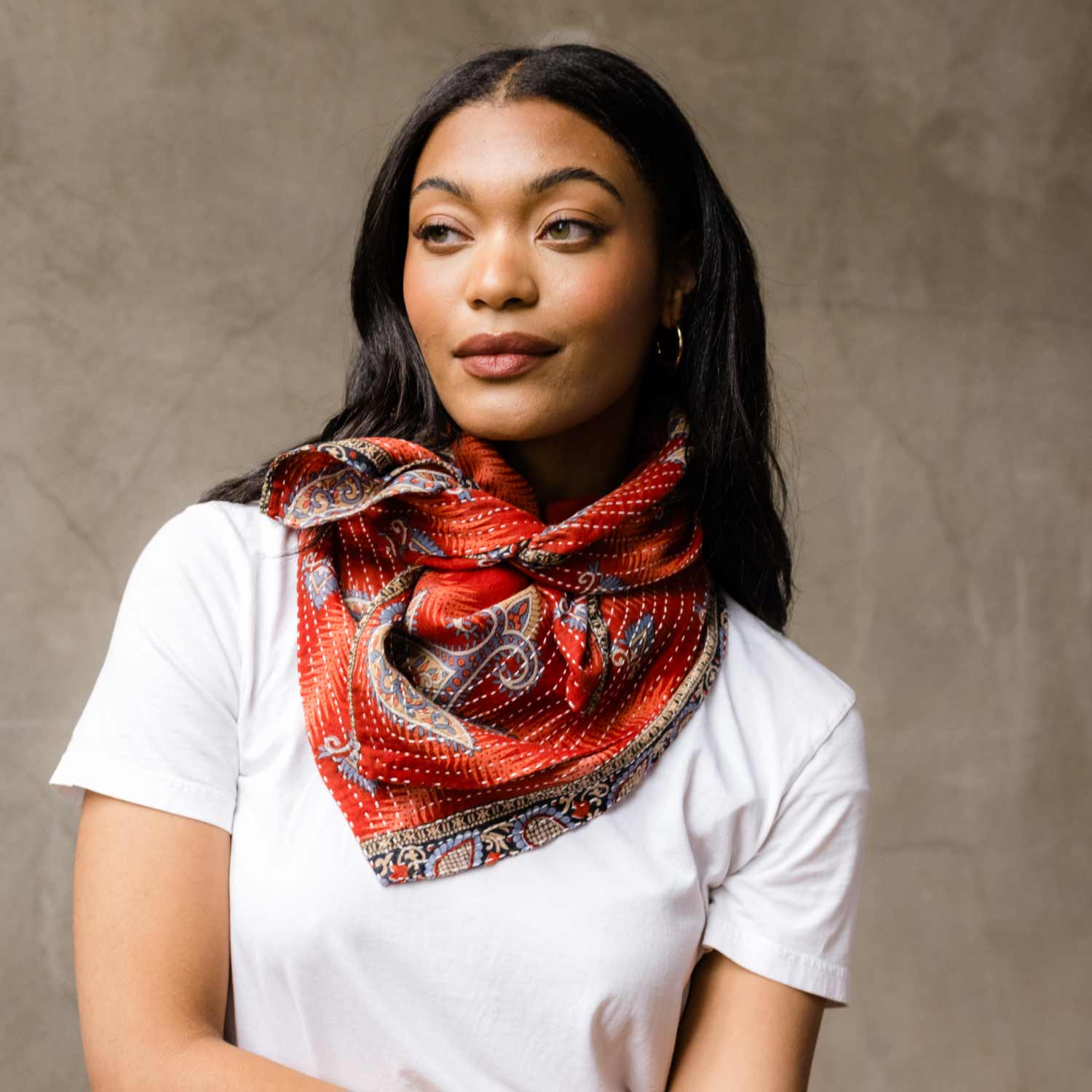 woman wearing burnt orange cotton square scarf against a white t-shirt