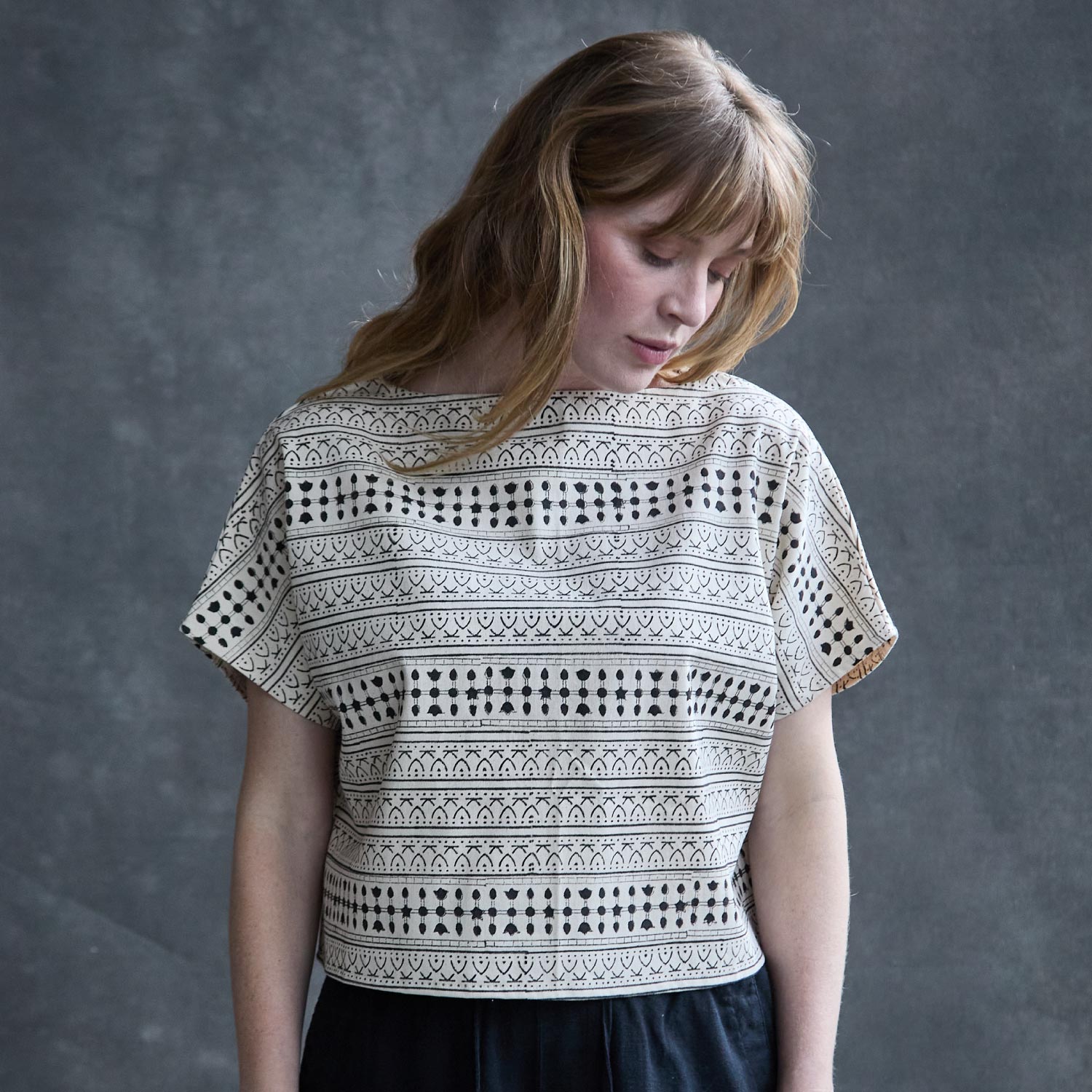 woman wearing block print crop top in black and white stripe pattern