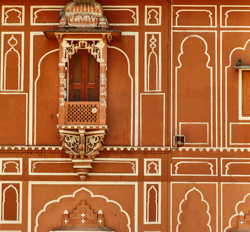 bold white & terracotta painted archway designs on building in Indian architecture