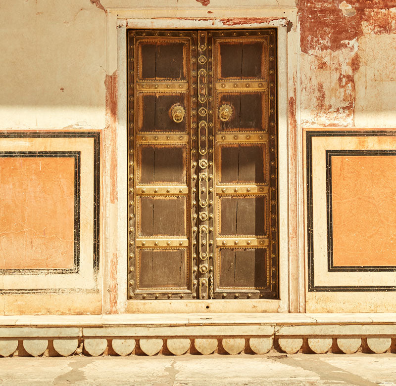 intricate wooden and brass door on building in Jaipur, India