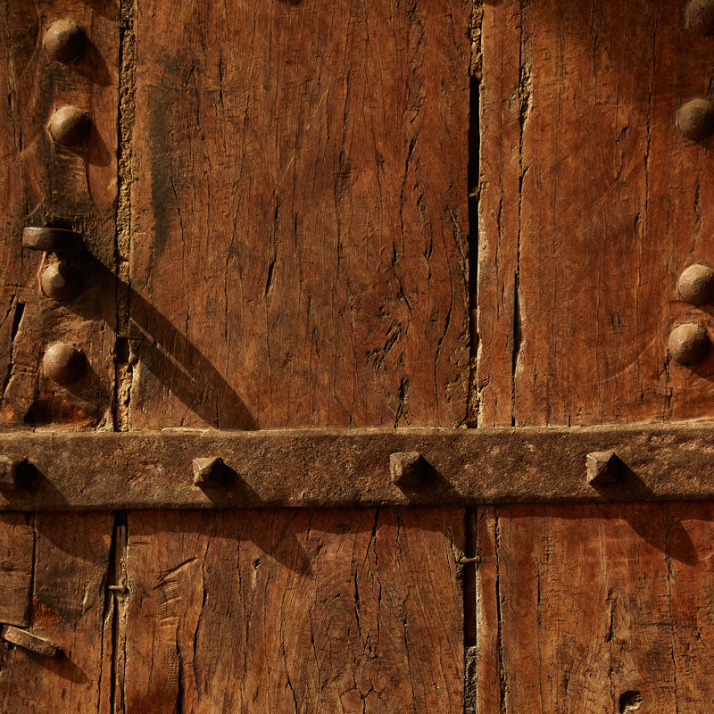 detailed wooden details of rustic door on Indian building in Ajmer, India