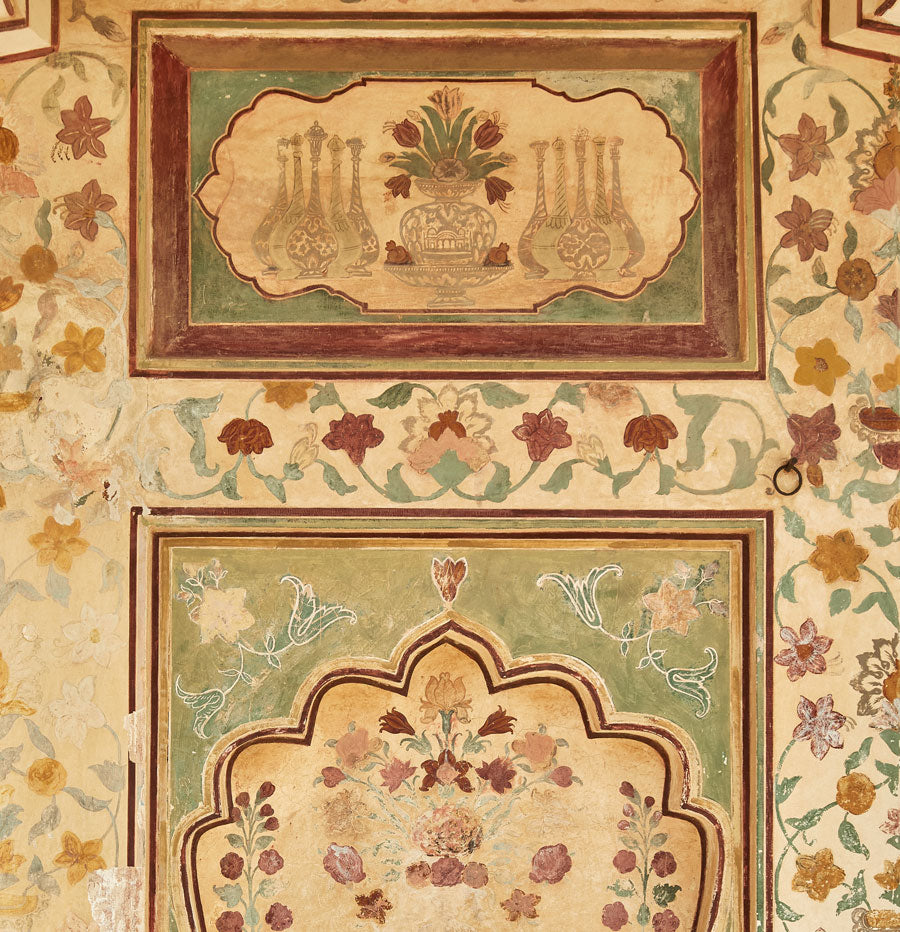 hand-painted walls in Jaipur palace featuring sage green, maroon, yellow and pink florals