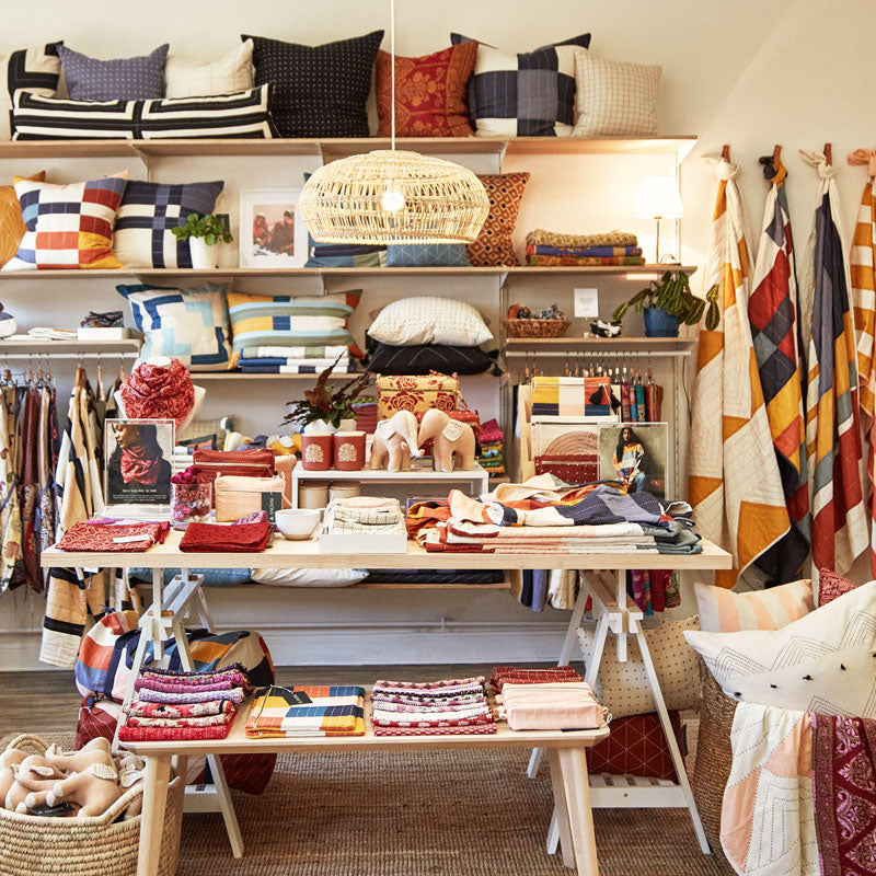 colorful merchandising of wall and table inside of Anchal's Louisville, KY storefront