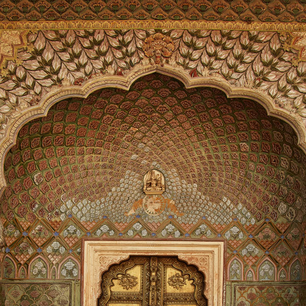 peacock inspired tile work on Indian building with solid brass intricate door in India