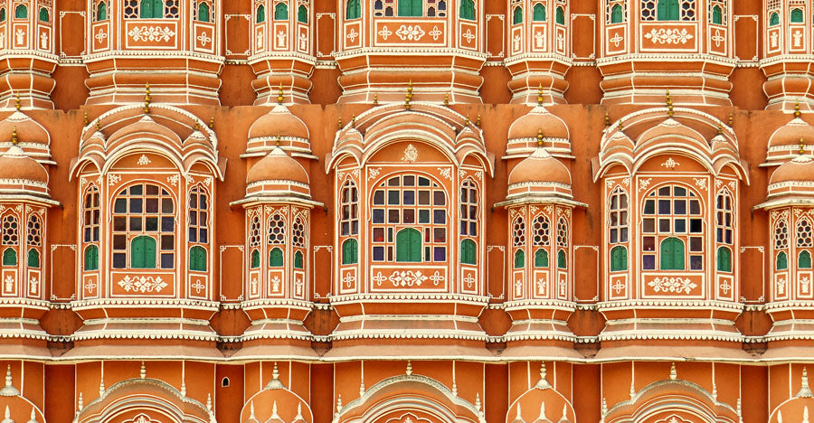  architectural detail of palace in Jaipur's Pink City featuring colors of terracotta, emerald green & white