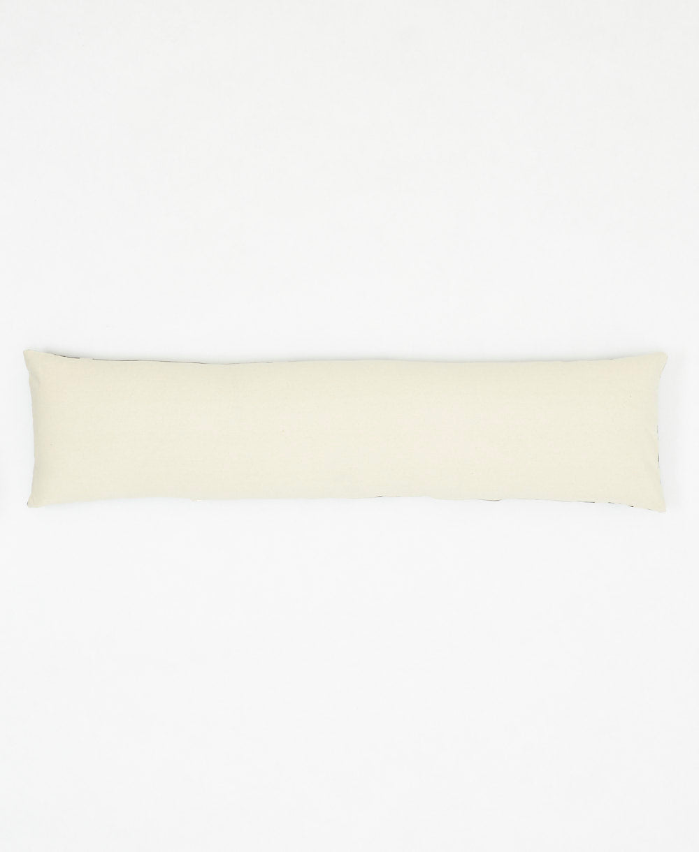 long lumbar pillow with interlock pattern on front and solid natural white backing made from organic cotton twill