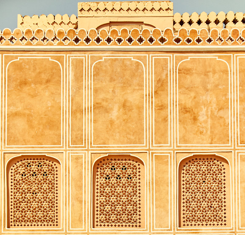 Indian architecture in palace in Jaipur featuring yellow jali screens