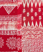 kantha quilt throw with a tag featuring the hand-stitched signature of the maker