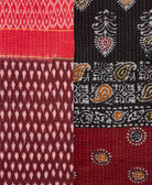 kantha quilt throw with a tag featuring the hand-stitched signature of the maker