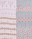 kantha quilt throw with a tag featuring the hand-stitched signature of the maker