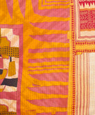 kantha quilt throw with a tag featuring the hand-stitched signature of the maker
