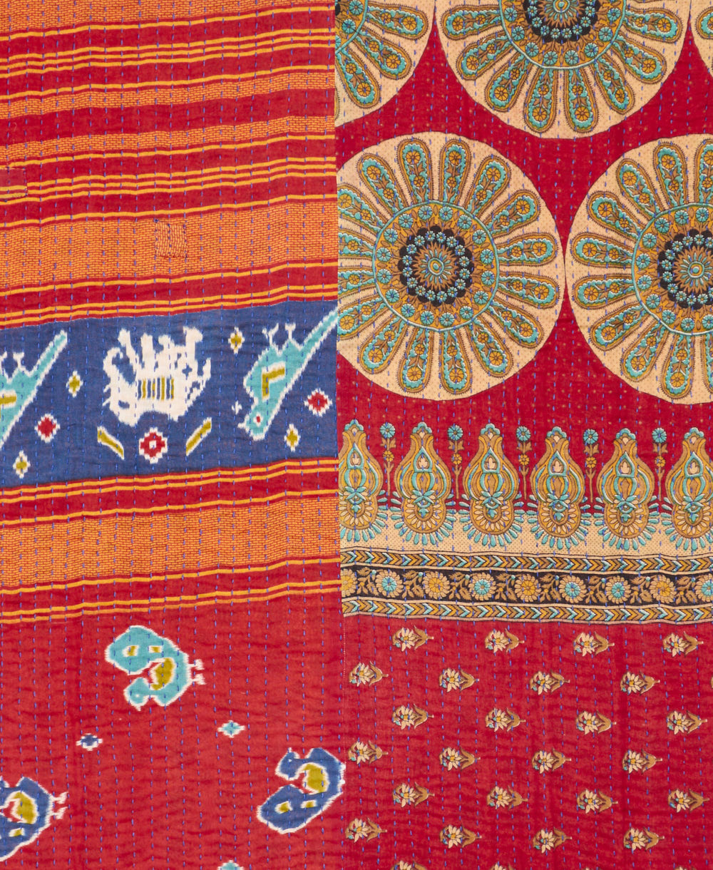 kantha quilt throw with a tag featuring the hand-stitched signature of the maker