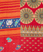 kantha quilt throw with a tag featuring the hand-stitched signature of the maker