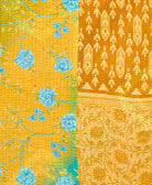 kantha quilt throw with a tag featuring the hand-stitched signature of the maker