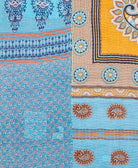kantha quilt throw with a tag featuring the hand-stitched signature of the maker