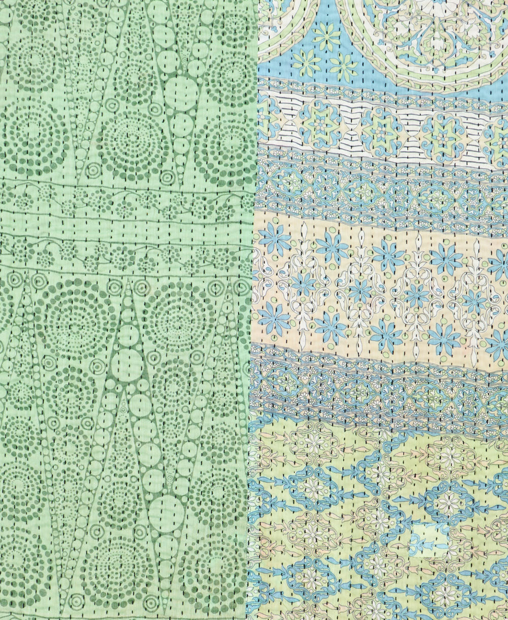 kantha quilt throw with a tag featuring the hand-stitched signature of the maker