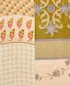kantha quilt throw with a tag featuring the hand-stitched signature of the maker