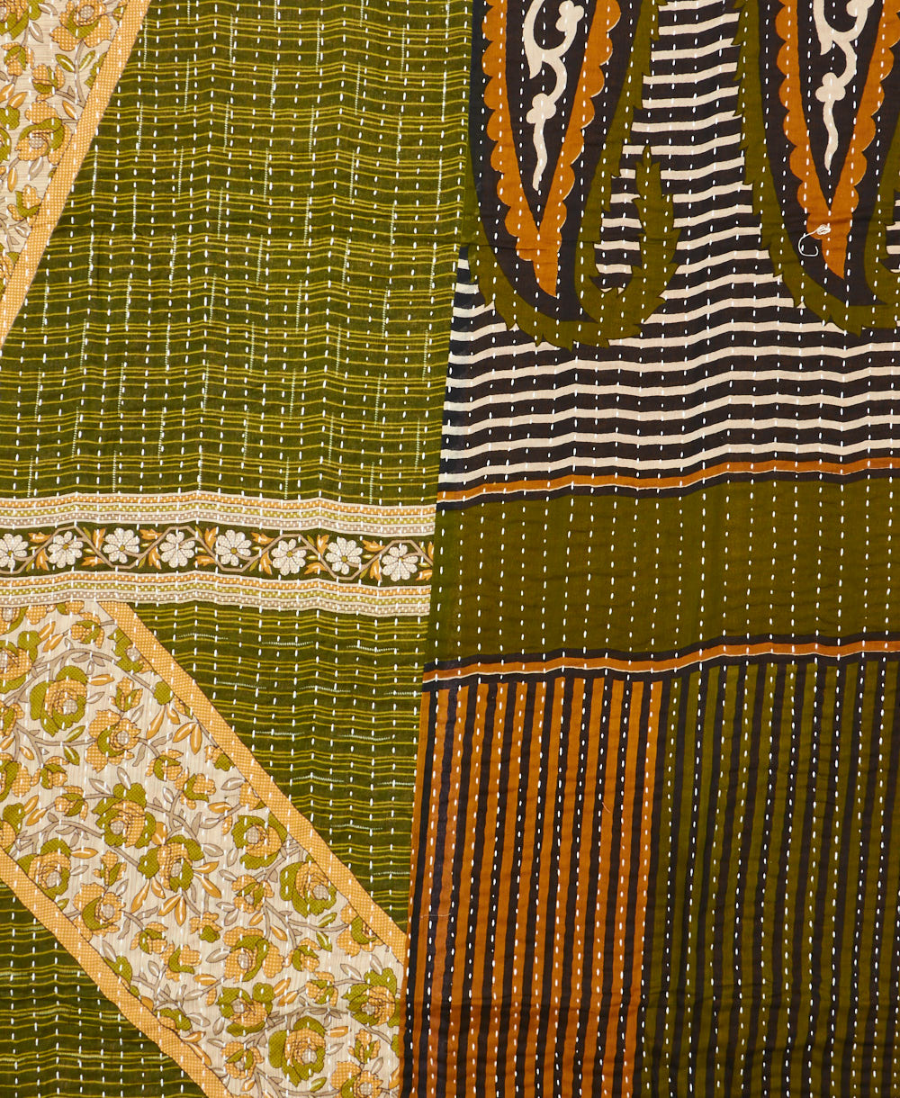 kantha quilt throw with a tag featuring the hand-stitched signature of the maker