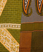 kantha quilt throw with a tag featuring the hand-stitched signature of the maker