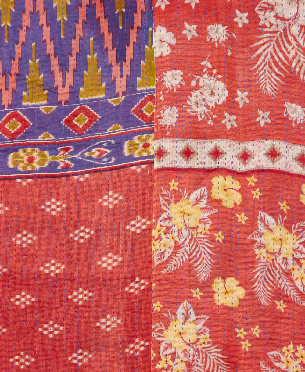 kantha quilt throw with a tag featuring the hand-stitched signature of the maker
