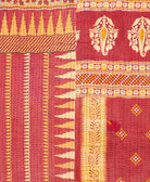 kantha quilt throw with a tag featuring the hand-stitched signature of the maker