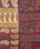 kantha quilt throw with a tag featuring the hand-stitched signature of the maker