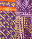 kantha quilt throw with a tag featuring the hand-stitched signature of the maker