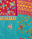 kantha quilt throw with a tag featuring the hand-stitched signature of the maker
