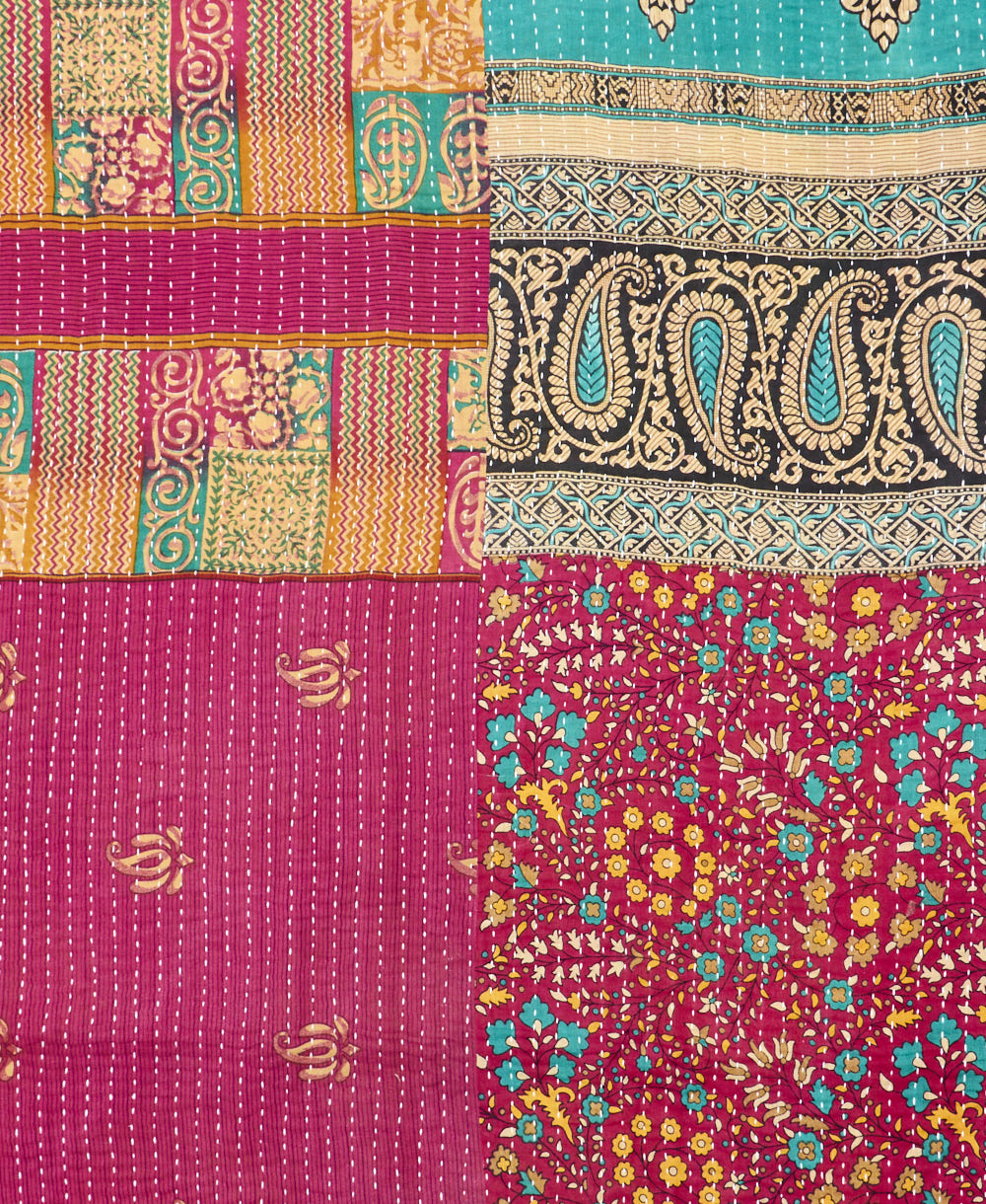 kantha quilt throw with a tag featuring the hand-stitched signature of the maker