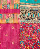 kantha quilt throw with a tag featuring the hand-stitched signature of the maker