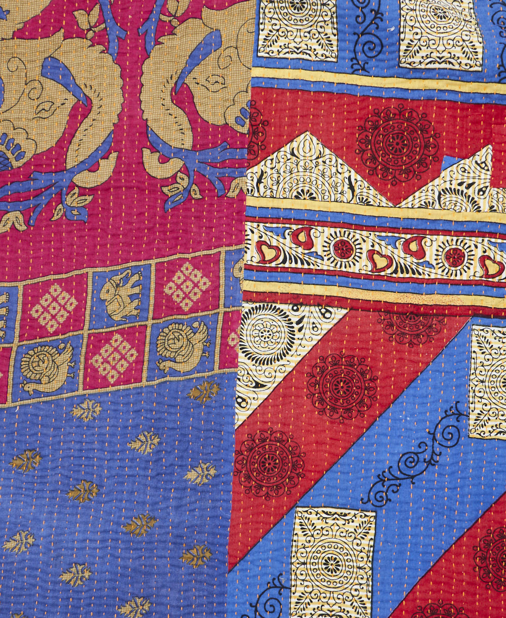 kantha quilt throw with a tag featuring the hand-stitched signature of the maker