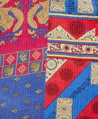 kantha quilt throw with a tag featuring the hand-stitched signature of the maker