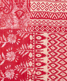 kantha quilt throw with a tag featuring the hand-stitched signature of the maker