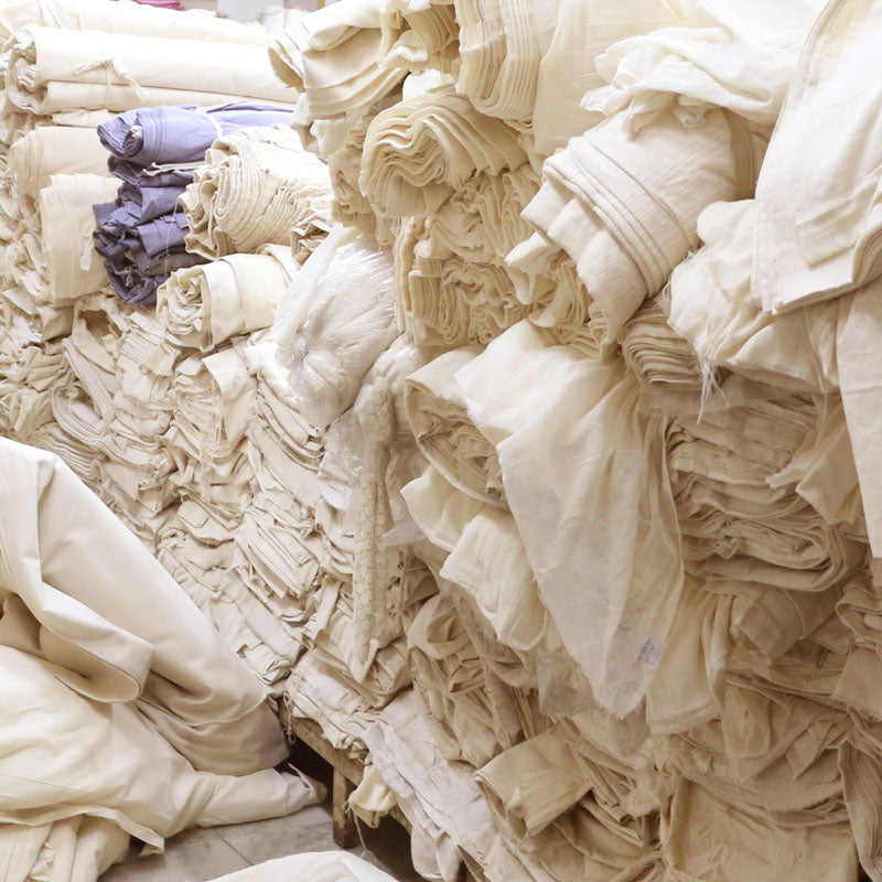 stacks and rolls of organic cotton fabric used to make most of Anchal's products