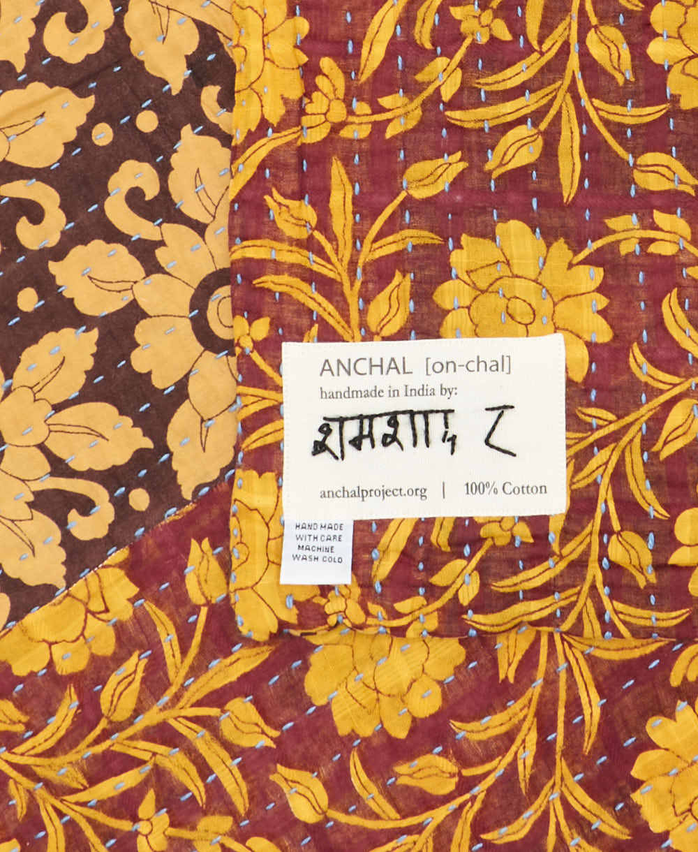 small kantha blanketwith signature of the maker on the tag
