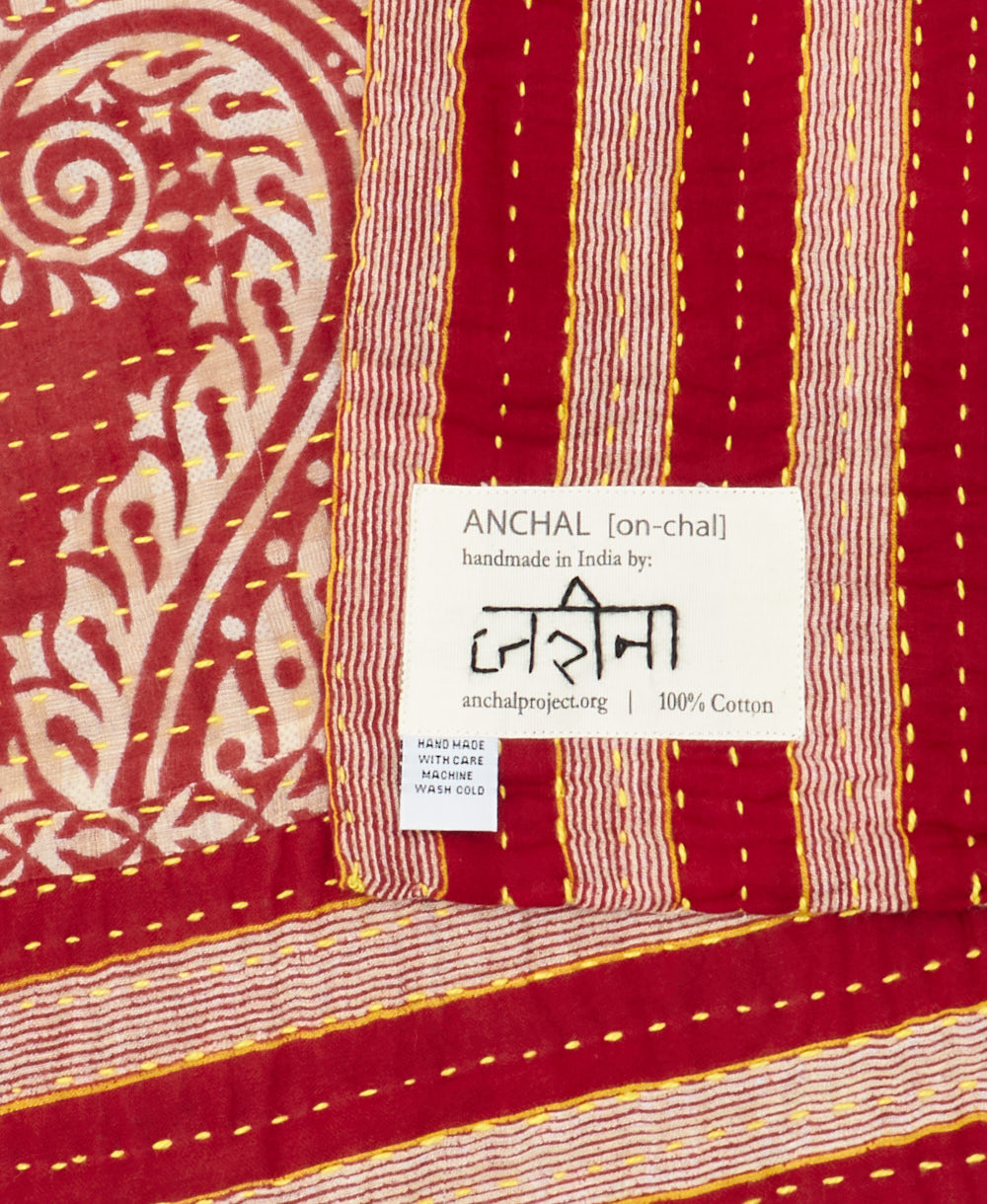 small kantha blanketwith signature of the maker on the tag