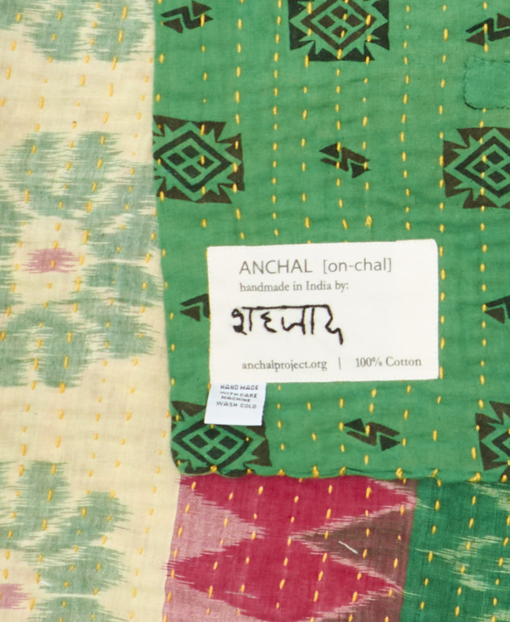 small kantha blanketwith signature of the maker on the tag