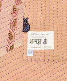 small kantha blanketwith signature of the maker on the tag