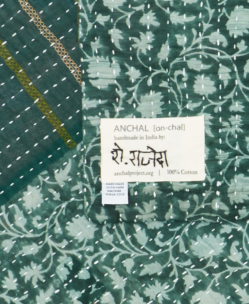 small kantha blanketwith signature of the maker on the tag