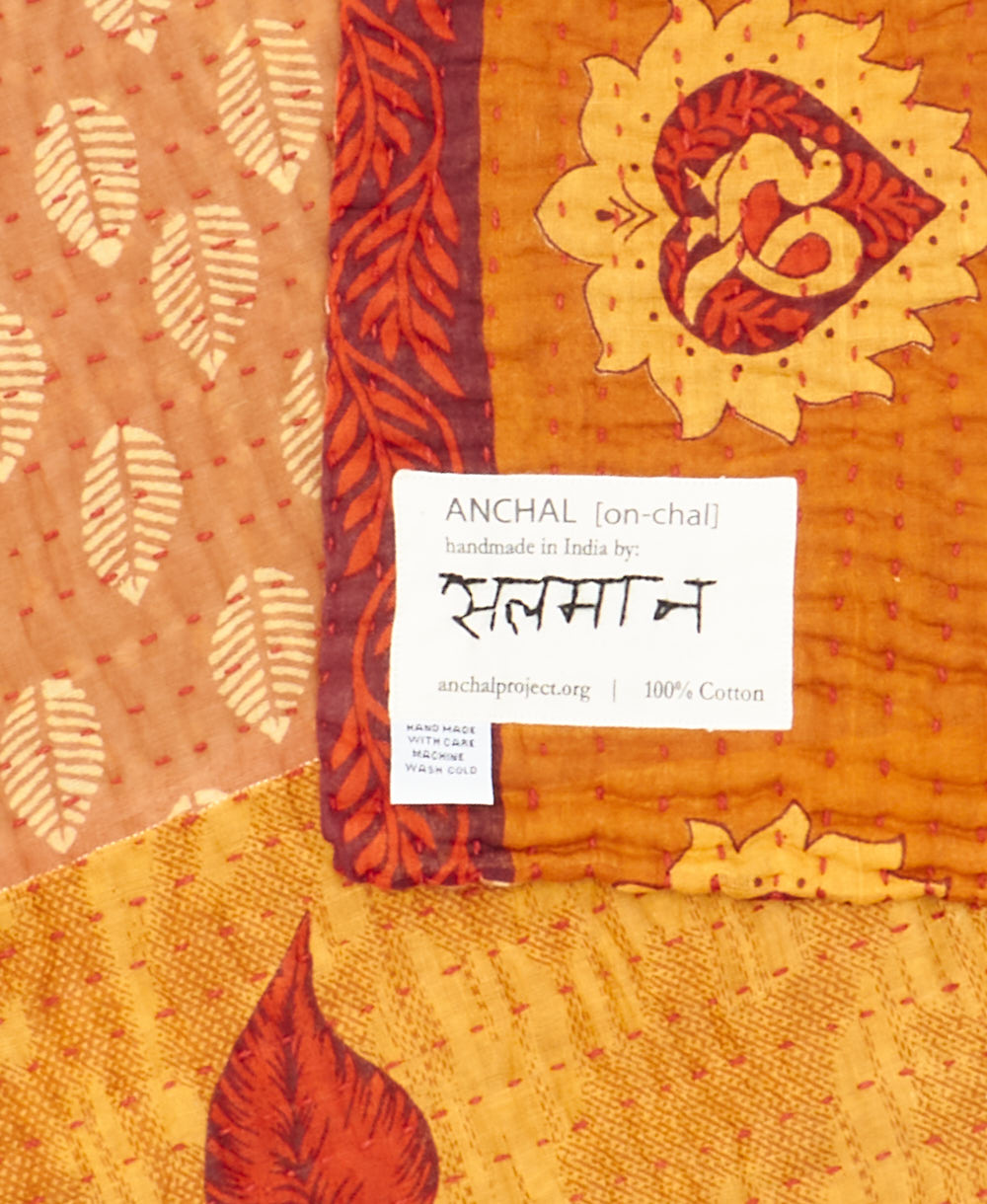 small kantha blanketwith signature of the maker on the tag